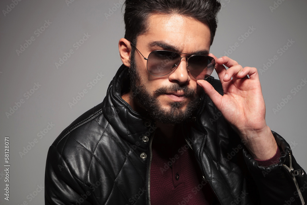 man with long beard fixing or putting on his sunglasses man with long beard fixing or putting on his sunglasses