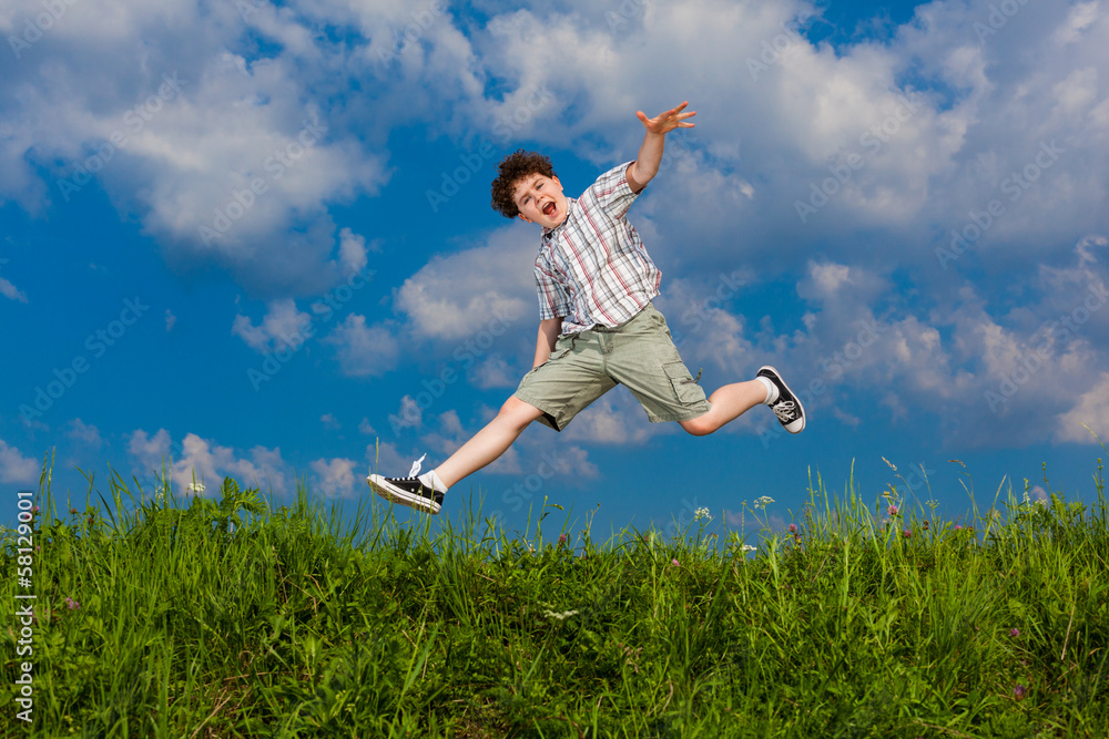 Boy jumping, running against blue sky Boy jumping, running against blue sky