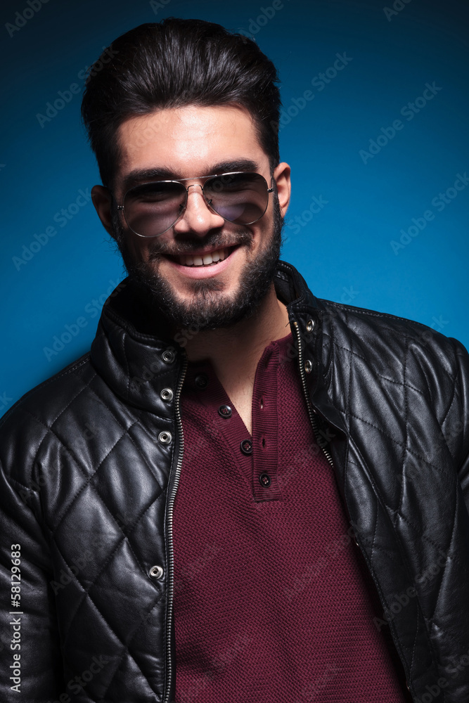 confident young man with long beard smiling confident young man with long beard smiling