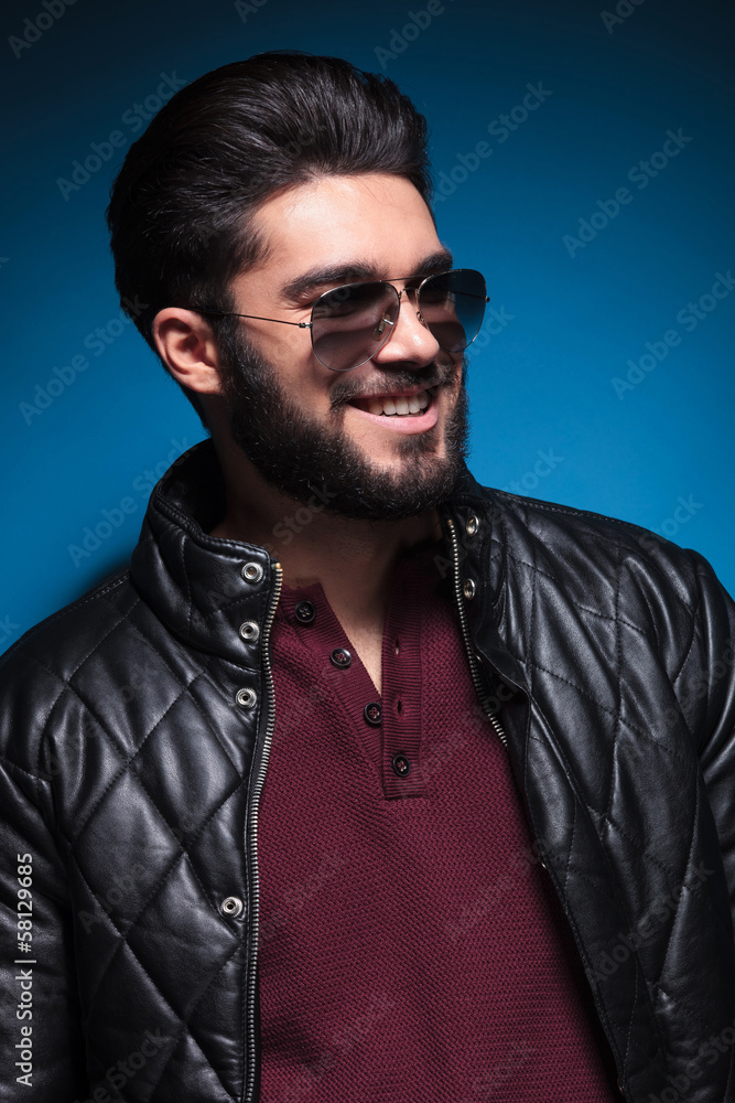 side of a young man with nice hairstyle and beard smiling side of a young man with nice hairstyle and beard smiling