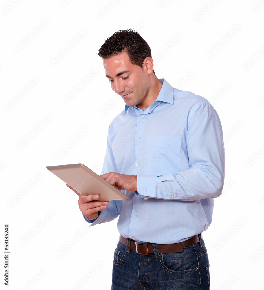 Charismatic young man looking at his tablet pc Charismatic young man looking at his tablet pc