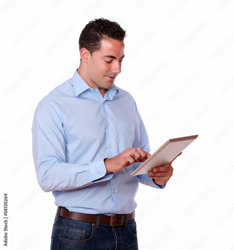 Adult male looking at his tablet pc Adult male looking at his tablet pc