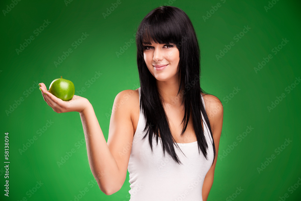 beautiful brunette woman with green apple on green background beautiful brunette woman with green apple on green background