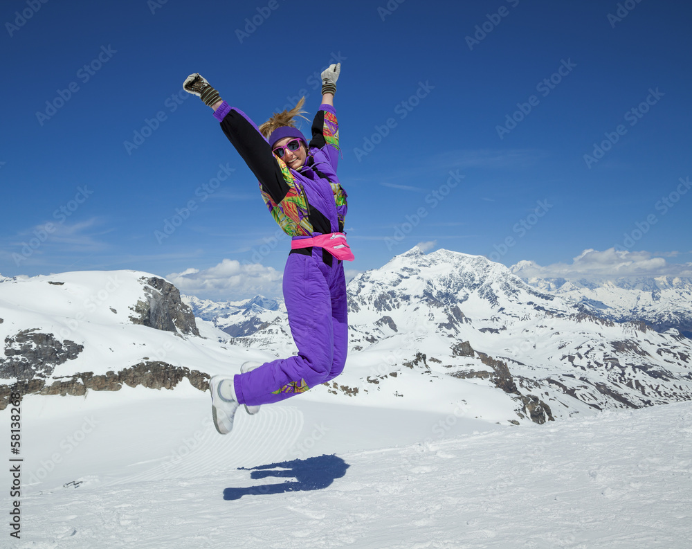 Happy woman jumping in the mountains