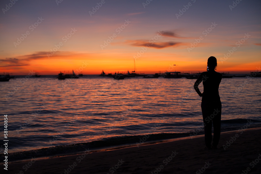 Girl photographing a sunset