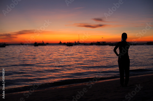 Girl photographing a sunset