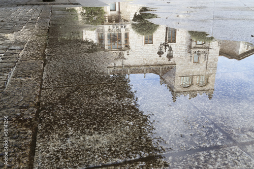 reflection in puddle house of the cord,spain photo