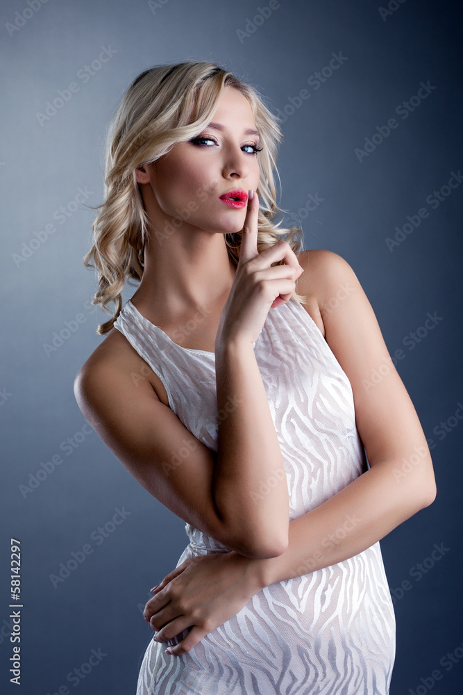 Studio shot of stylish young blonde in white dress Studio shot of stylish young blonde in white dress