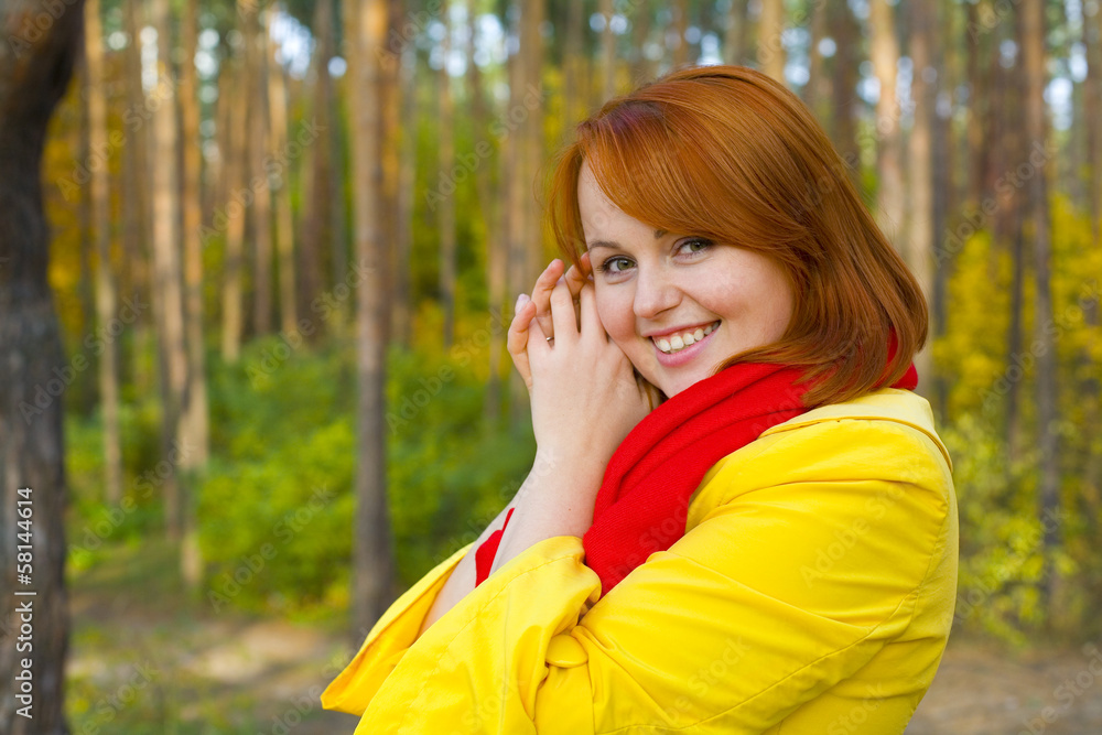 Portrait of red-haired girl outdoors