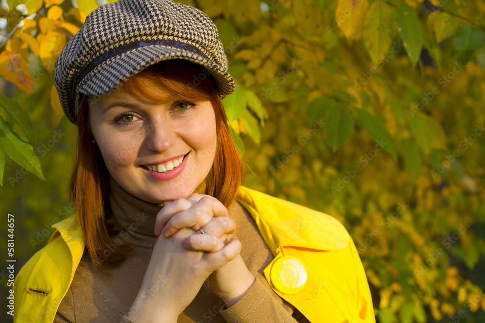 Attractive red-haired girl in the autumn wood