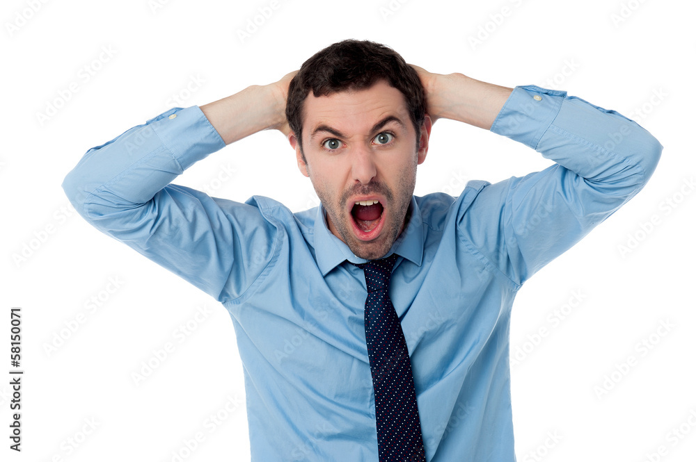 Angry businessman with hands on his head Angry businessman with hands on his head