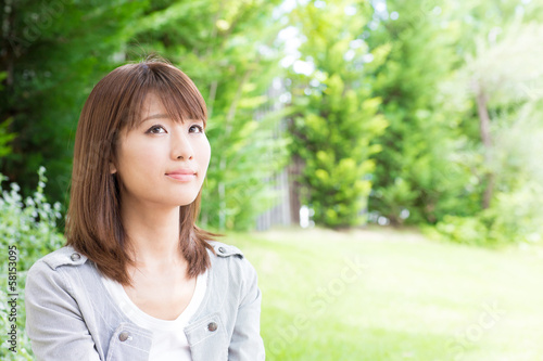 young asian woman relaxing in the park