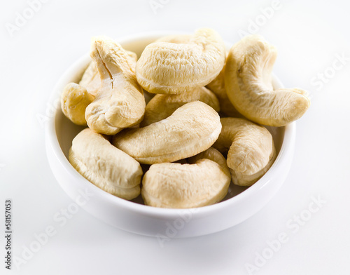 Cashew. Heap of nuts isolated on white background. Selective foc