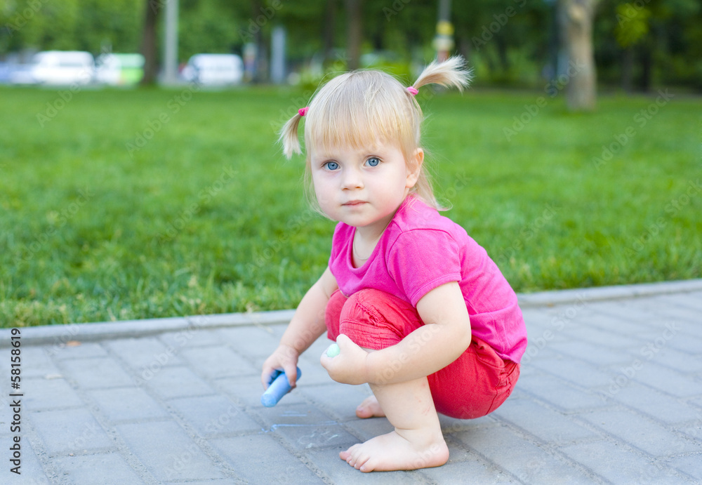 Attractive baby at a playground in the summer Attractive baby at a playground in the summer