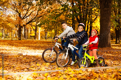 Group of kids riding in autumn park