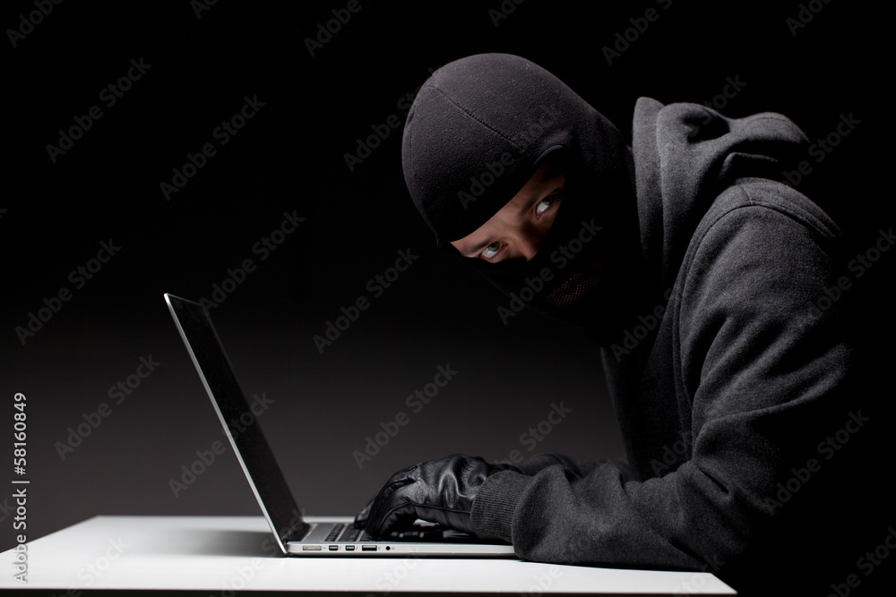 Computer hacker in a balaclava Computer hacker in a balaclava