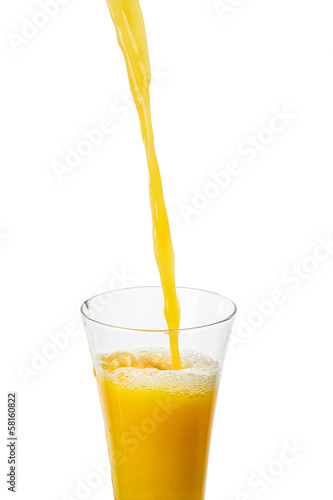 Orange juice is pouring on a white background