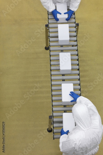 aerial view of two workersworking  on packing line photo