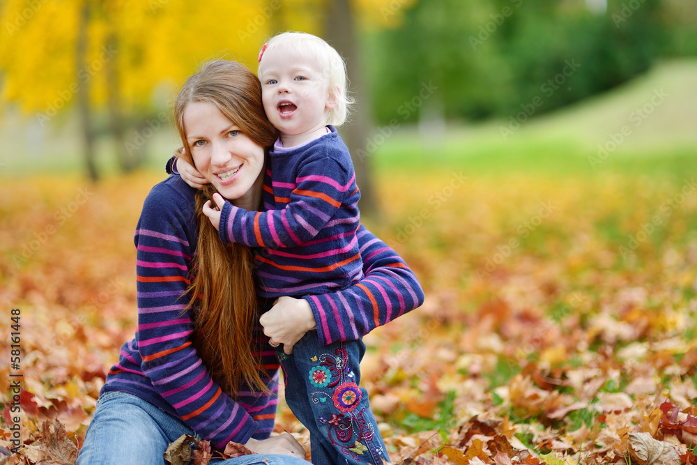 Young mother and toddler girl have fun at autumn Young mother and toddler girl have fun at autumn