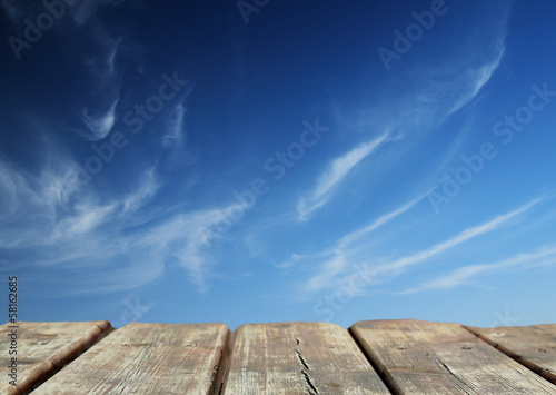 blue sky with old wooden table background
