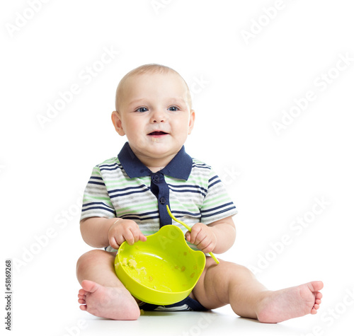 baby with a spoon and plate