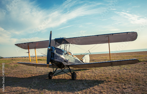 Fototapeta Naklejka Na Ścianę i Meble -  Biplane - vintage aircraft on airfield