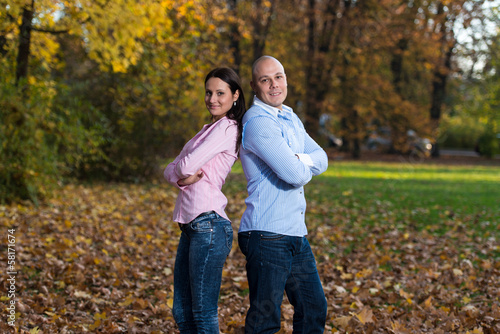 Happy Young Couple With Arms Crossed