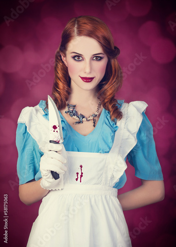 Portrait of a young redhead woman dressed as Alice in Wonderland photo