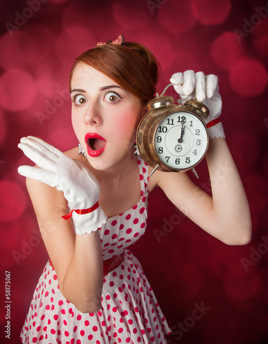 Beautiful redhead women with clock.