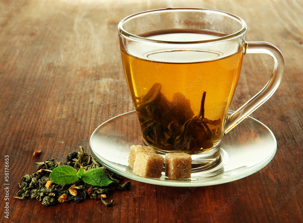 Transparent cup of green tea on wooden background Transparent cup of green tea on wooden background