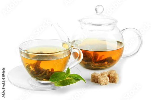 Cup and teapot of green tea with mint and sugar isolated