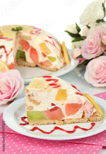 Delicious jelly cake on table on white background