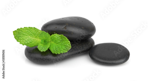 Fresh mint on the black stones with drops