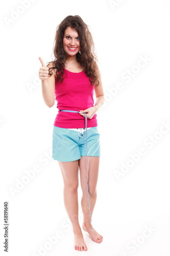 sporty fit woman with measure tape thumbs up