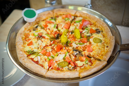 Fresh mexican pizza with hot jalapeno pepper on metal plate in p