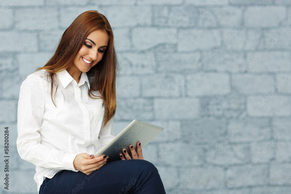 Young happy businesswoman with tablet computer in office Young happy businesswoman with tablet computer in office