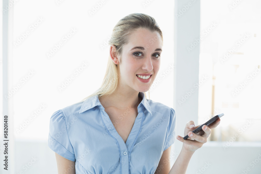Cute businesswoman holding her smartphone