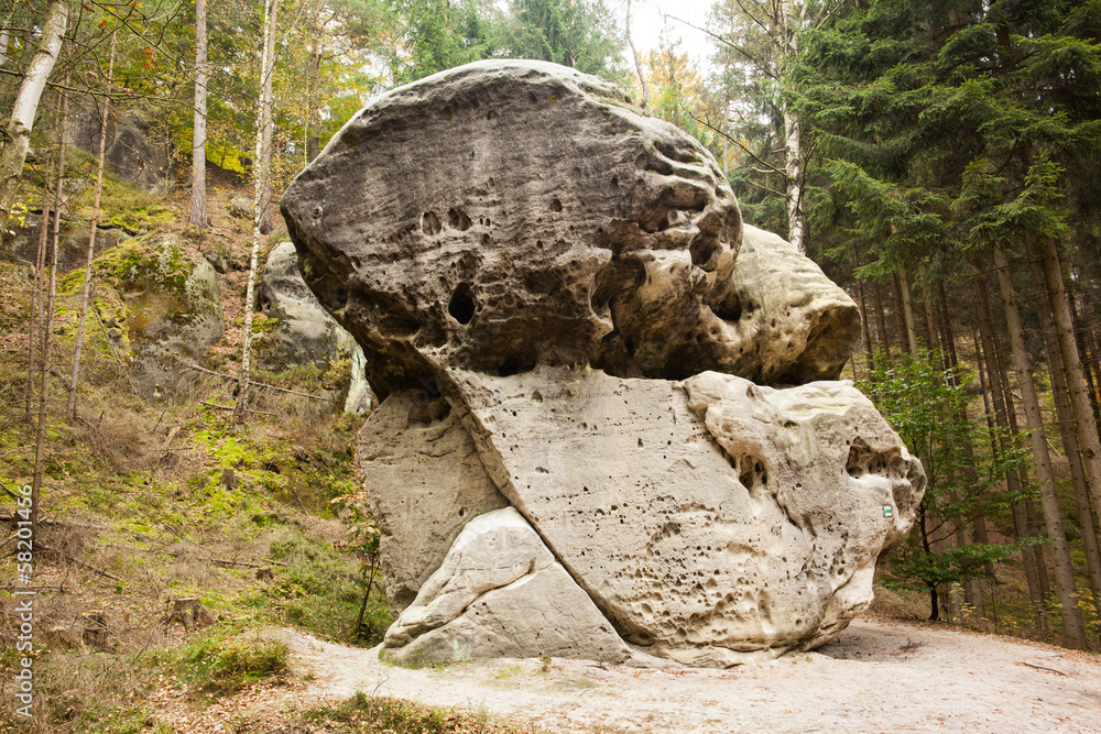 Large natural rock against trees Large natural rock against trees