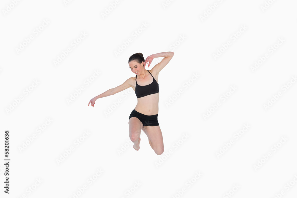 Full length of a sporty young woman jumping Full length of a sporty young woman jumping
