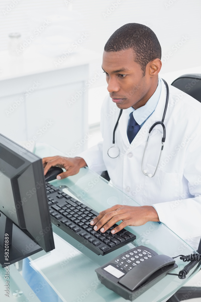 Doctor using computer at medical office Doctor using computer at medical office