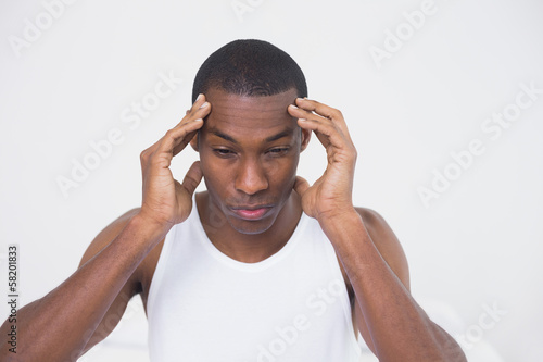 Close up of a young Afro man suffering from headache