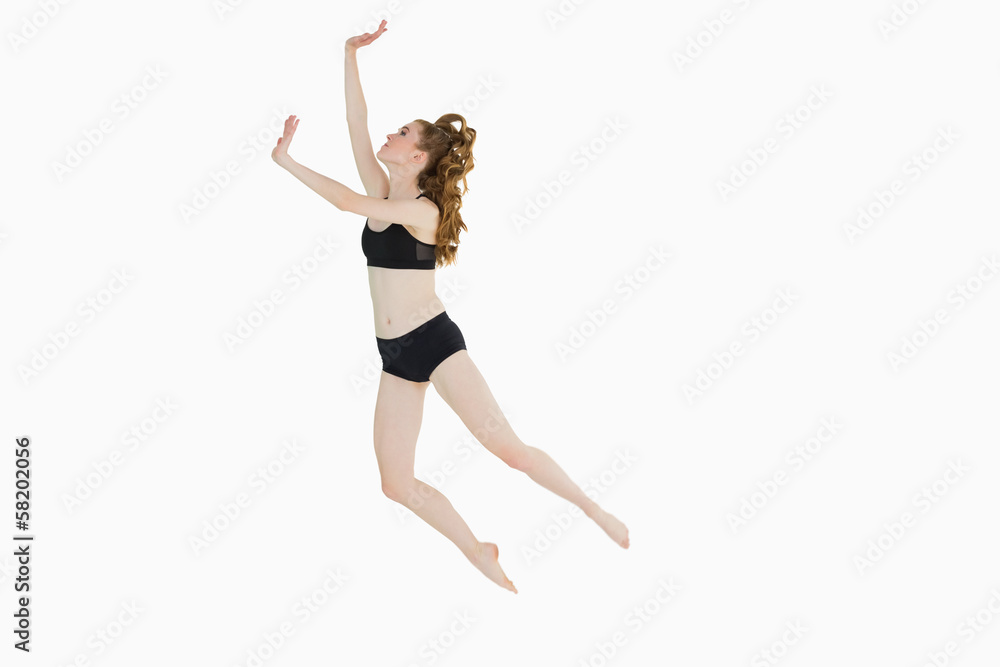 Full length of a sporty young woman jumping Full length of a sporty young woman jumping