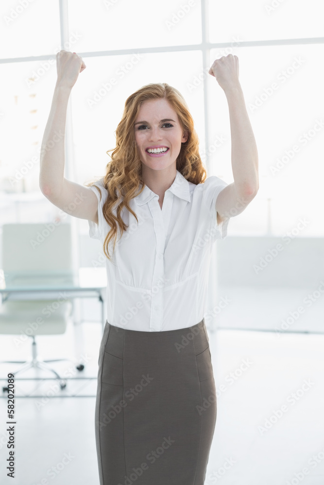 Cheerful elegant businesswoman cheering in office Cheerful elegant businesswoman cheering in office