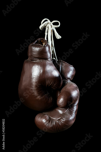 old Boxing Gloves, hanging, isolated on black Background © Ezio Gutzemberg