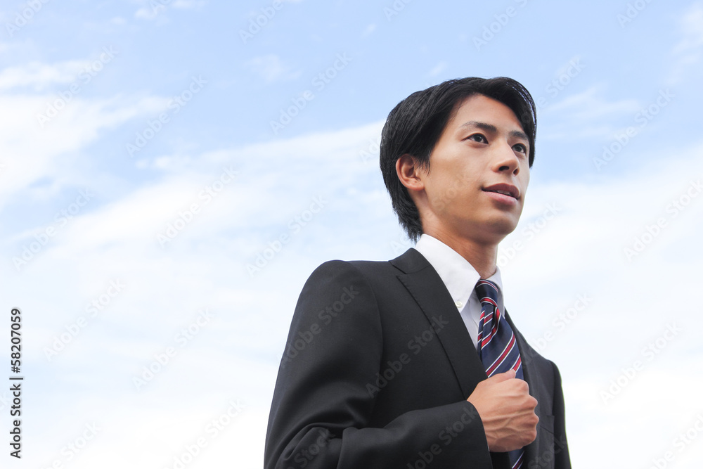 A businessman looking up at the sky A businessman looking up at the sky