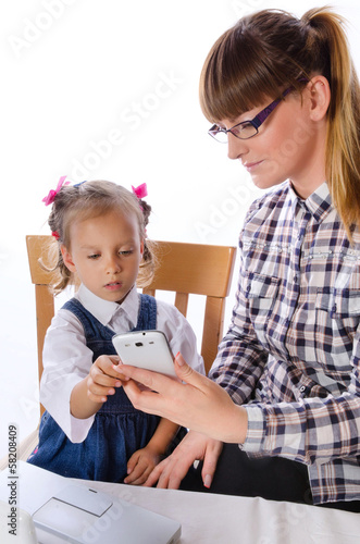 mother and daughter with mobile phone photo