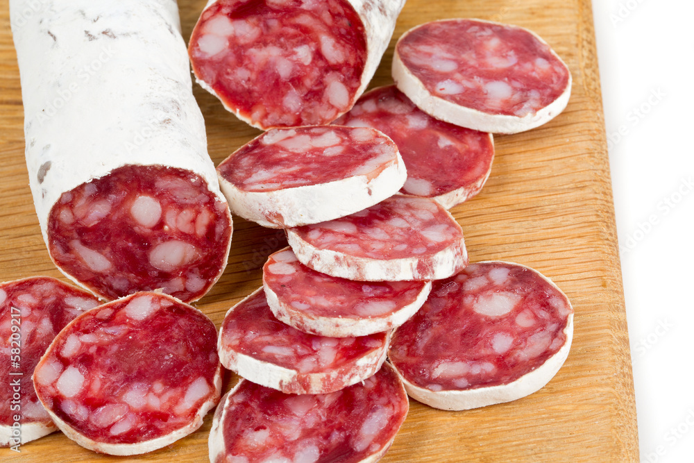sliced salami isolated on cutting board sliced salami isolated on cutting board
