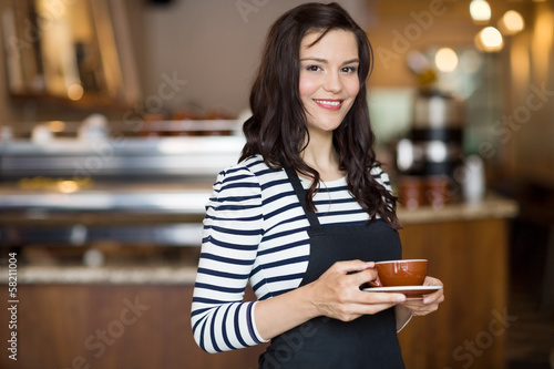 Beautiful Waitress Holding Coffee Cup In Cafeteria