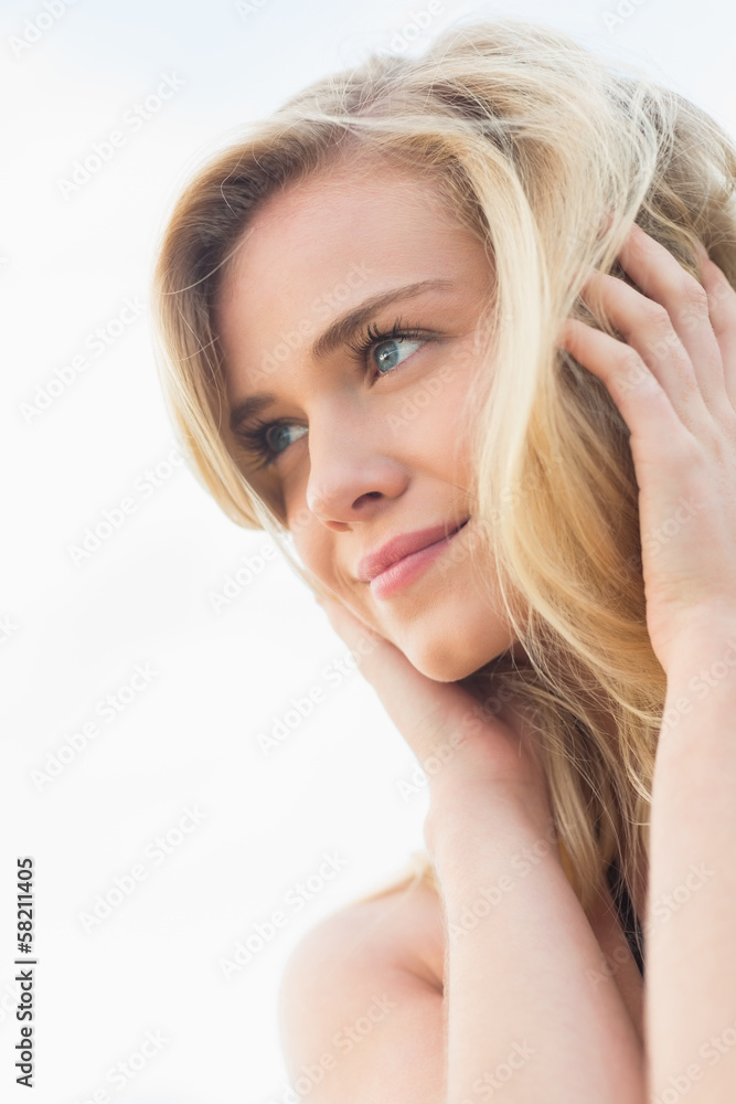 Close up of a smiling relaxed blond looking away