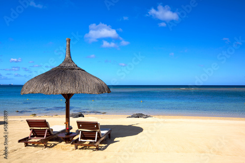 Tropical beach with chairs and umbrella in Mauritius © Oleksandr Dibrova